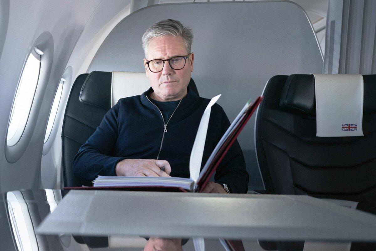 Britain's Prime Minister Sir Keir Starmer poses for a photograph as he works while travelling on a government aeroplane en route to attend the G20 summit in Rio de Janeiro, Brazil, on Nov. 17, 2024. (Stefan Rousseau/POOL/AFP via Getty Images)