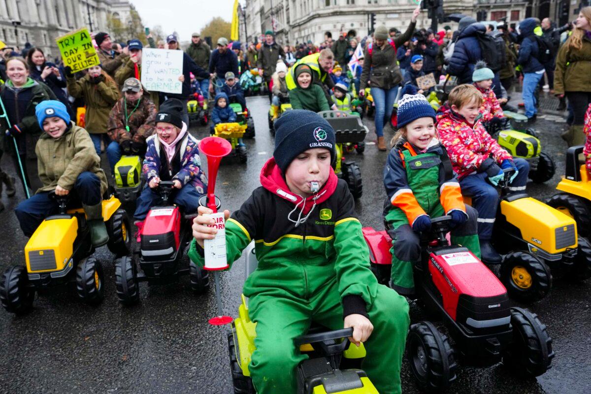 Children ride toy tractors in Parliament Square as demonstrators attend a farmers' rally in London on Nov. 19, 2024. (Carl Court/Getty Images)