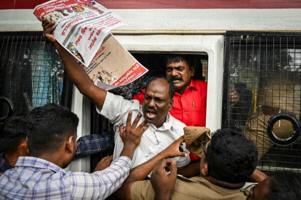 Police personnel detain a member of the Communist Party of India (CPI-M) during a protest against Indian Prime Minister Narendra Modi and billionaire businessman Gautam Adani, calling for the tycoon's arrest over corruption allegations by U.S. prosecutors, in Chennai, India, on Nov. 23, 2024. (<span style="font-weight: 400;">R.Satish Babu</span>/AFP via Getty Images)