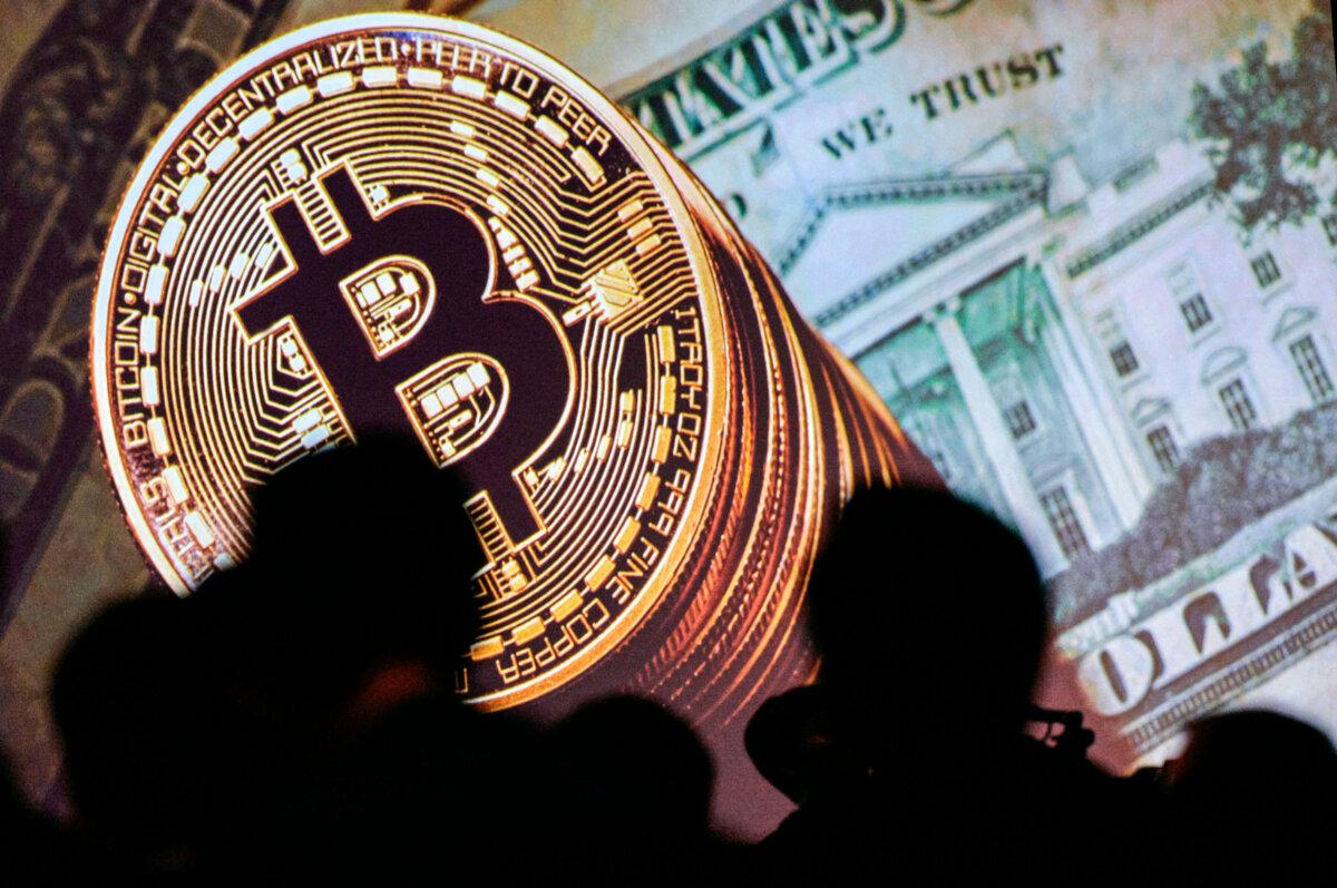 A bitcoin logo is displayed on a screen as delegates listen to speakers during the Interpol World Congress in Singapore on July 4, 2017. (Dominic Gwinn/AFP via Getty Images)