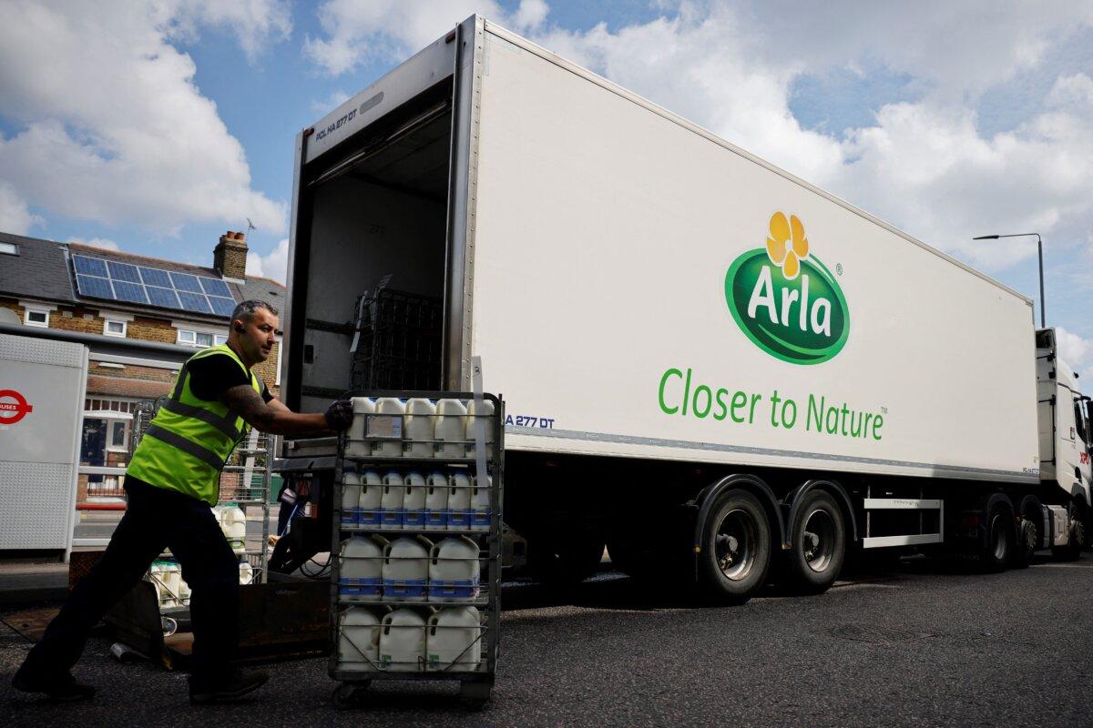 A lorry driver for Arla Foods, a dairy products company, makes a milk delivery to a Tesco supermarket in London on Aug. 3, 2021. (Tolga Akmen/AFP via Getty Images)
