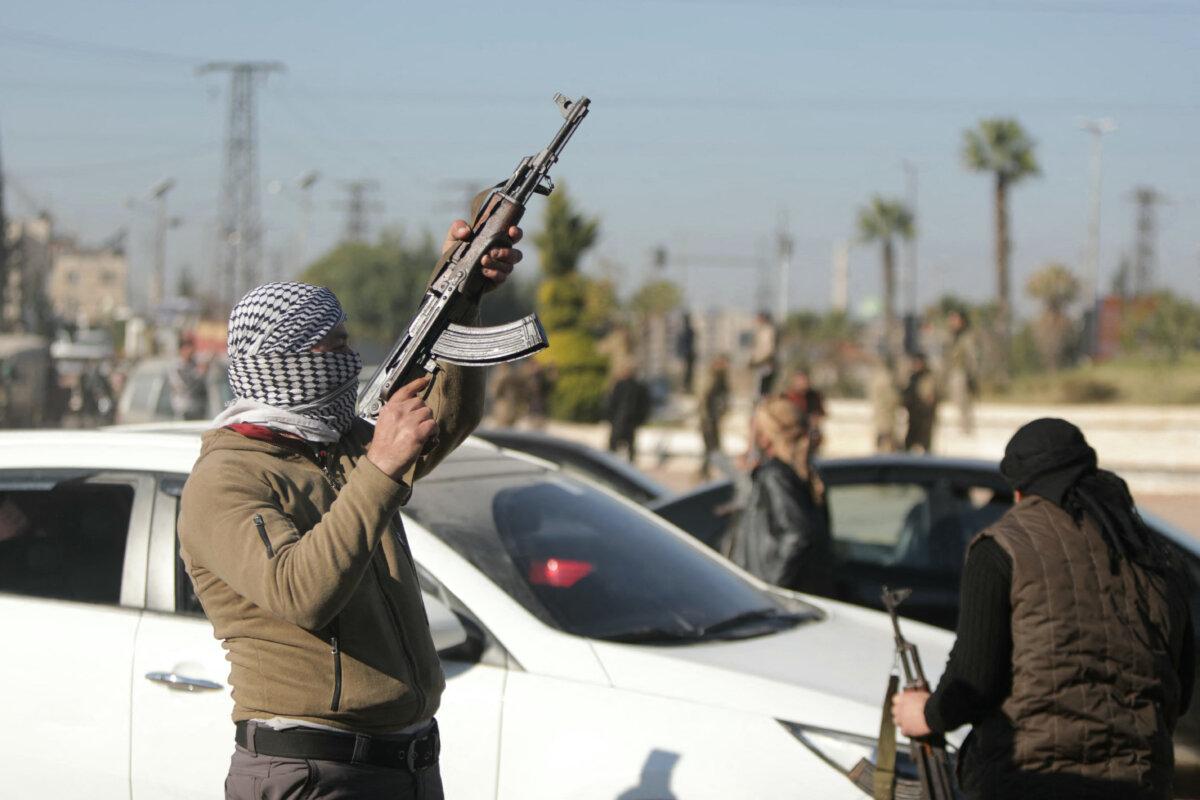An anti-government fighter fires into the air in Aleppo, Syria, on Nov. 30, 2024. (Bakr Alkasem/AFP via Getty Images)
