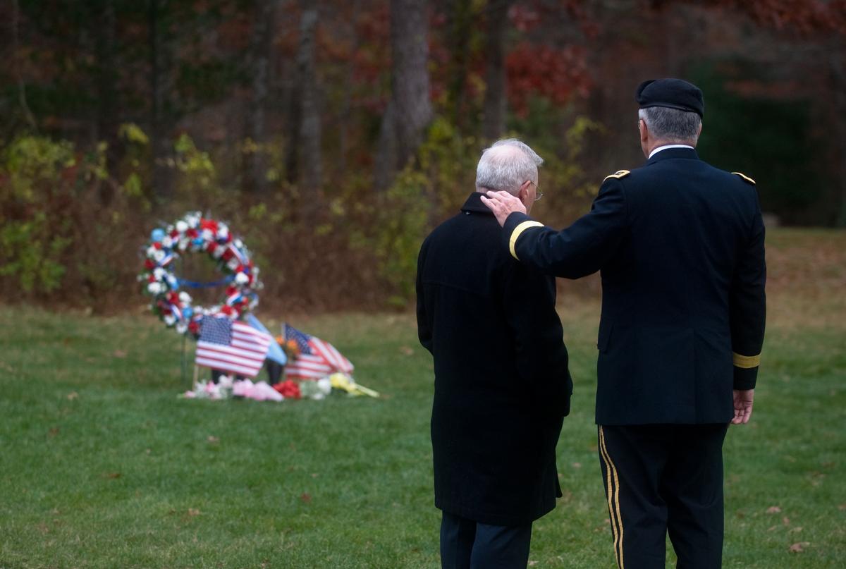 (L) Paul Monti, father of Medal of Honor recipient Jared Monti, and Army Chief of Staff Gen. George W. Casey Jr. stand near Jared's gravesite on Veterans Day at the National Ceremony in Bourne, Mass. on Nov. 11, 2009. (Public Domain)