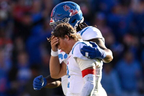 Mississippi quarterback Jaxson Dart (2) is consoled by offensive lineman Diego Pounds after throwing an interception late in the second half against Florida in Gainesville, Fla., on Nov. 23. (Phelan M. Ebenhack/AP Photo)