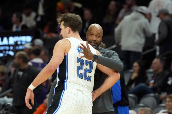 Orlando Magic forward Franz Wagner (22) celebrates with Magic head coach Jamahl Mosley, right, in the closing moments of the second half of an NBA basketball game against the Phoenix Suns in Phoenix on Nov. 18, 2024. (Ross D. Franklin/AP Photo)