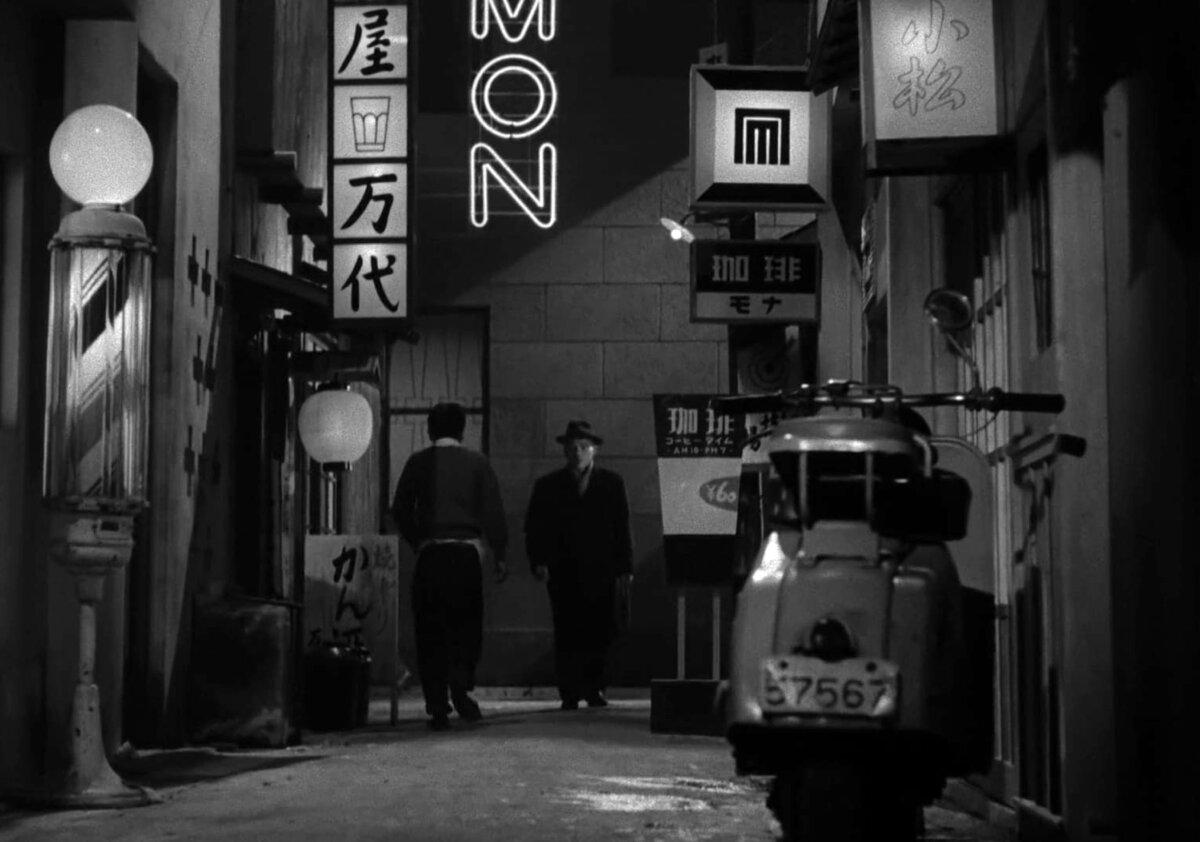The neon-lit alleyways of post-war Tokyo in a scene from “Tokyo Twilight.” (Shochiku).