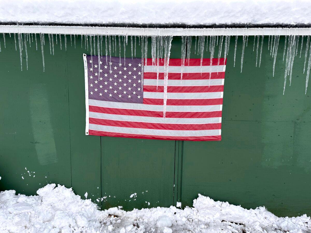 Icicles form over a flag during a snow storm in Lowville, N.Y., on Dec, 1, 2024. (Cara Anna/AP Photo)