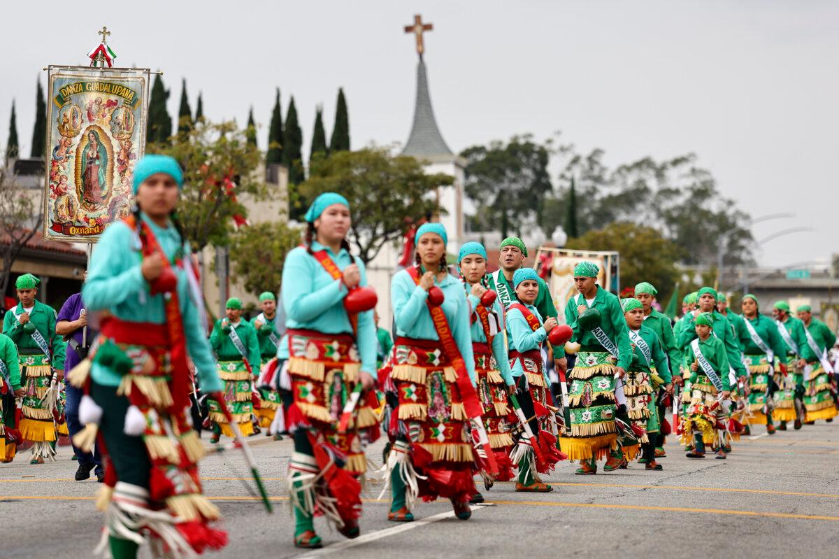 Members of Danza Guadalupana perform in the 91st Procession and Mass honoring Our Lady of Guadalupe and St. Juan Diego, in the traditionally Latino community of East Los Angeles, in Los Angeles on Dec. 4, 2022. (Mario Tama/Getty Images)