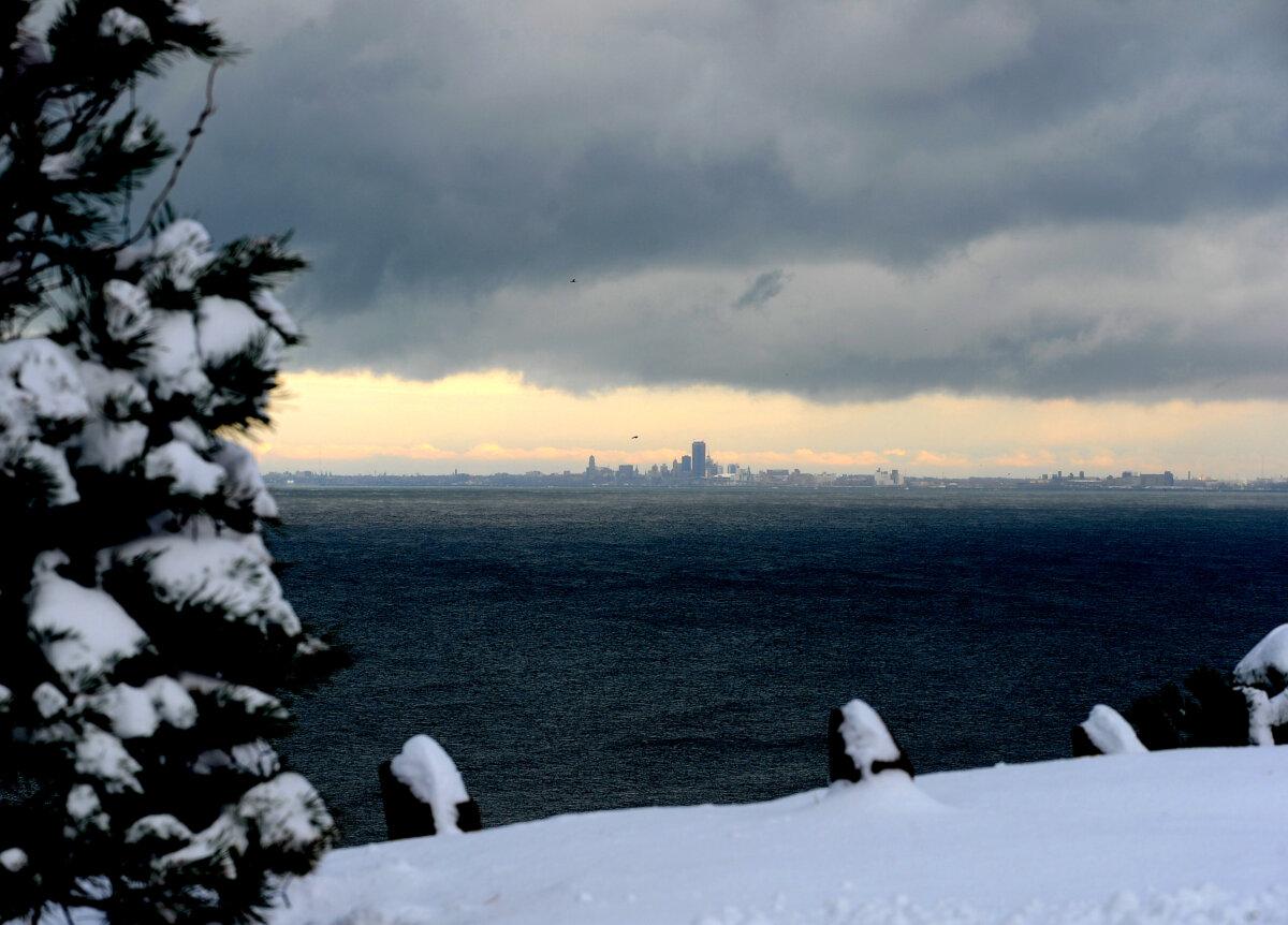 Lake effect snow clouds hang over Lake Erie and the Buffalo skyline as seen from Hamburg, N.Y., on Dec. 1, 2024. (John Normile/Getty Images)
