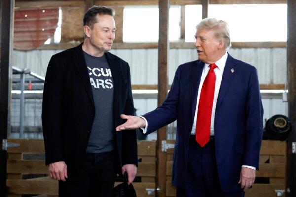 Republican presidential nominee, former President Donald Trump offers his hand to Tesla founder Elon Musk backstage during a campaign rally at the Butler Farm Show grounds in Butler, Pa., on Oct. 5, 2024. (Anna Moneymaker/Getty Images)