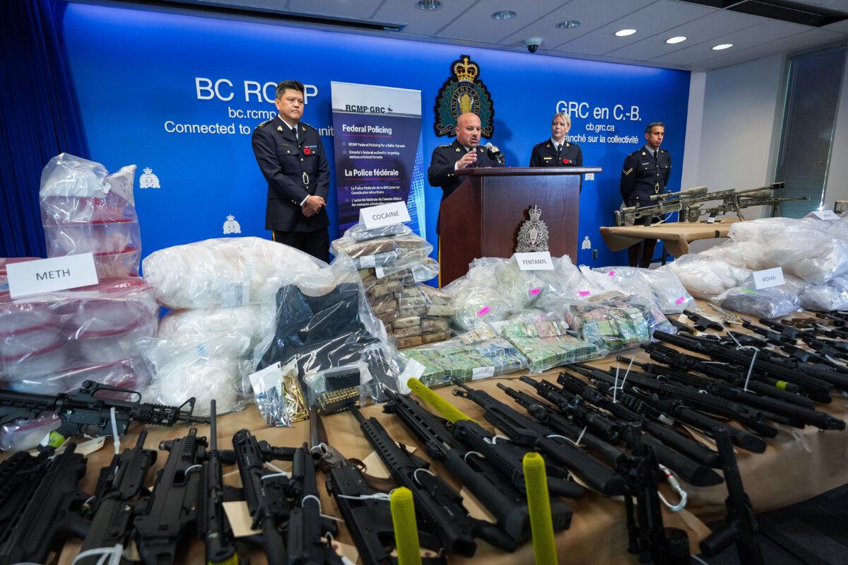 Firearms and illicit drugs seized at a superlab in Falkland, B.C., are displayed as David Teboul, assistant commissioner with the RCMP's Pacific region (C), holds a press conference in Surrey, B.C., on Oct. 31, 2024. (The Canadian Press/Darryl Dyck)