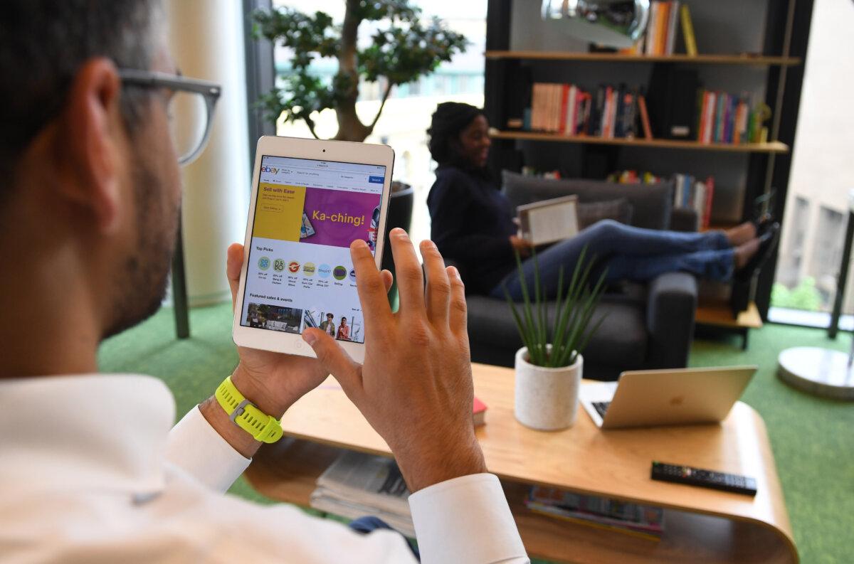 A person uses a shopping app in London on May 30, 2018. (Stuart C. Wilson/Getty Images)