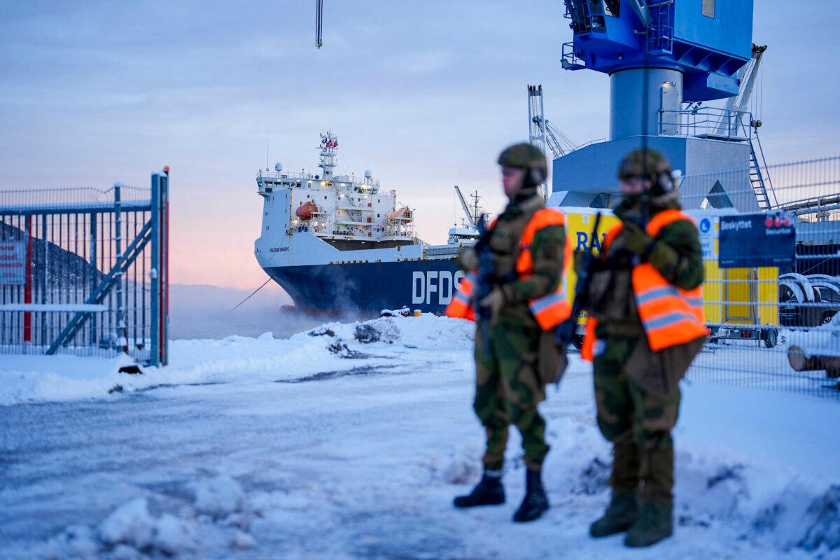 Norwegian soldiers stand in front of a ship as military equipment is made ready to be loaded onto the vessel at Orkanger Harbor, Norway, on Dec. 4, 2024. (Ole Martin Wold/NTB/AFP via Getty Images)