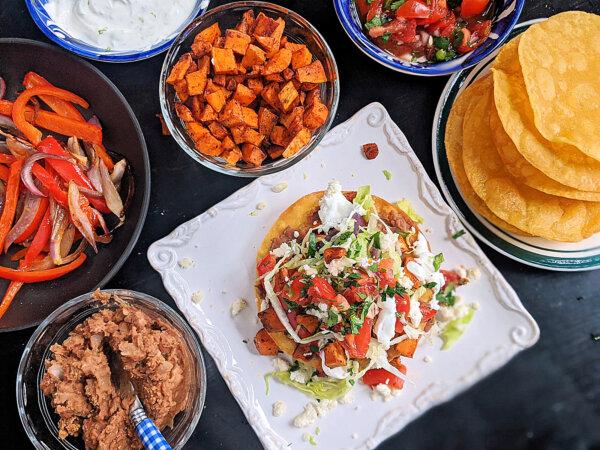 These vegetarian tostadas are stacked with two layers of smashed pinto beans, lettuce, pico and roasted sweet potatoes and bell peppers. Crumbled queso fresco and lime crema add the crowning touch. (Gretchen McKay/Pittsburgh Post-Gazette/TNS)