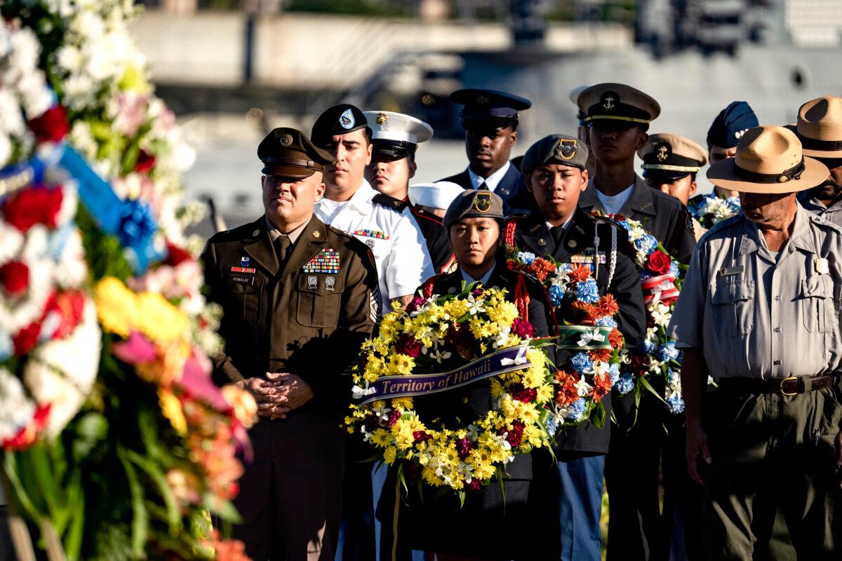 Servicemen and Park Service rangers present wreathes during the 83rd Pearl Harbor Remembrance Day ceremony in Honolulu on Dec. 7, 2024. (Mengshin Lin/AP Photo)