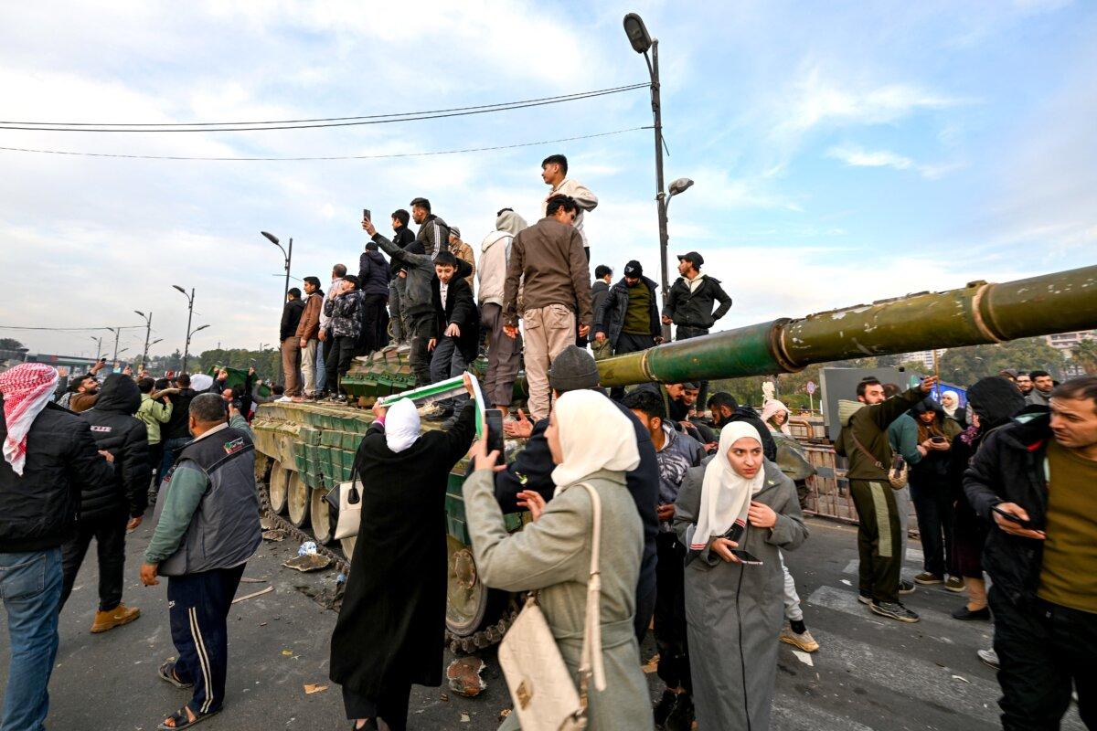 People celebrate at Umayyad Square in Damascus on Dec. 8, 2024. (Louai Beshara/AFP via Getty Images)