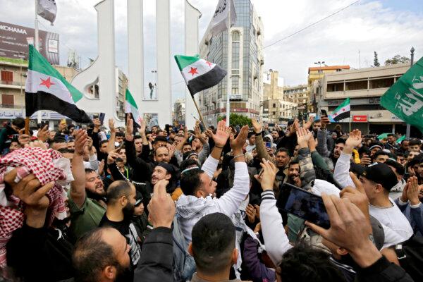 Syrian and Lebanese people celebrate the fall of the Syrian regime in the northern Lebanese city of Tripoli on Dec. 8, 2024. (Ibrahim Chalhoub/AFP via Getty Images)