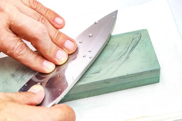 Sharpening a knife on a whetstone removes some of the steel to grind it to a sharp point. (stella_photo/Shutterstock)