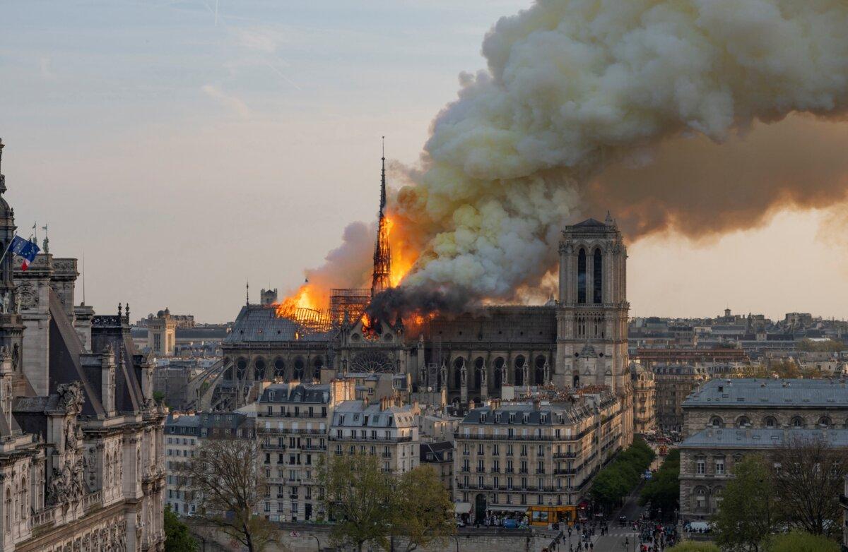 Smoke billows as flames burn through the roof of the Notre-Dame de Paris Cathedral in Paris on April 15, 2019. (Fabien Barrau/AFP via Getty Images)