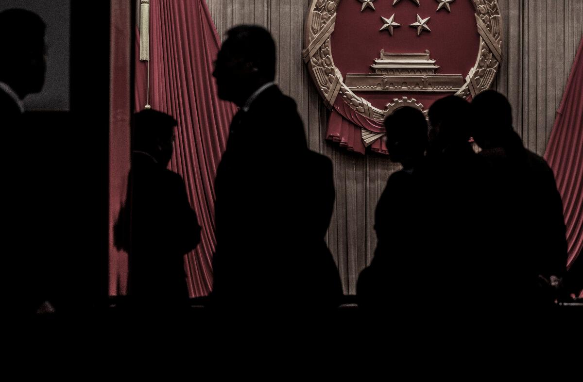 Delegates and security stand in the entranceway to the auditorium before the closing session of the National Peoples Congress at the Great Hall of the People in Beijing on March 11, 2024. (Kevin Frayer/Getty Images)