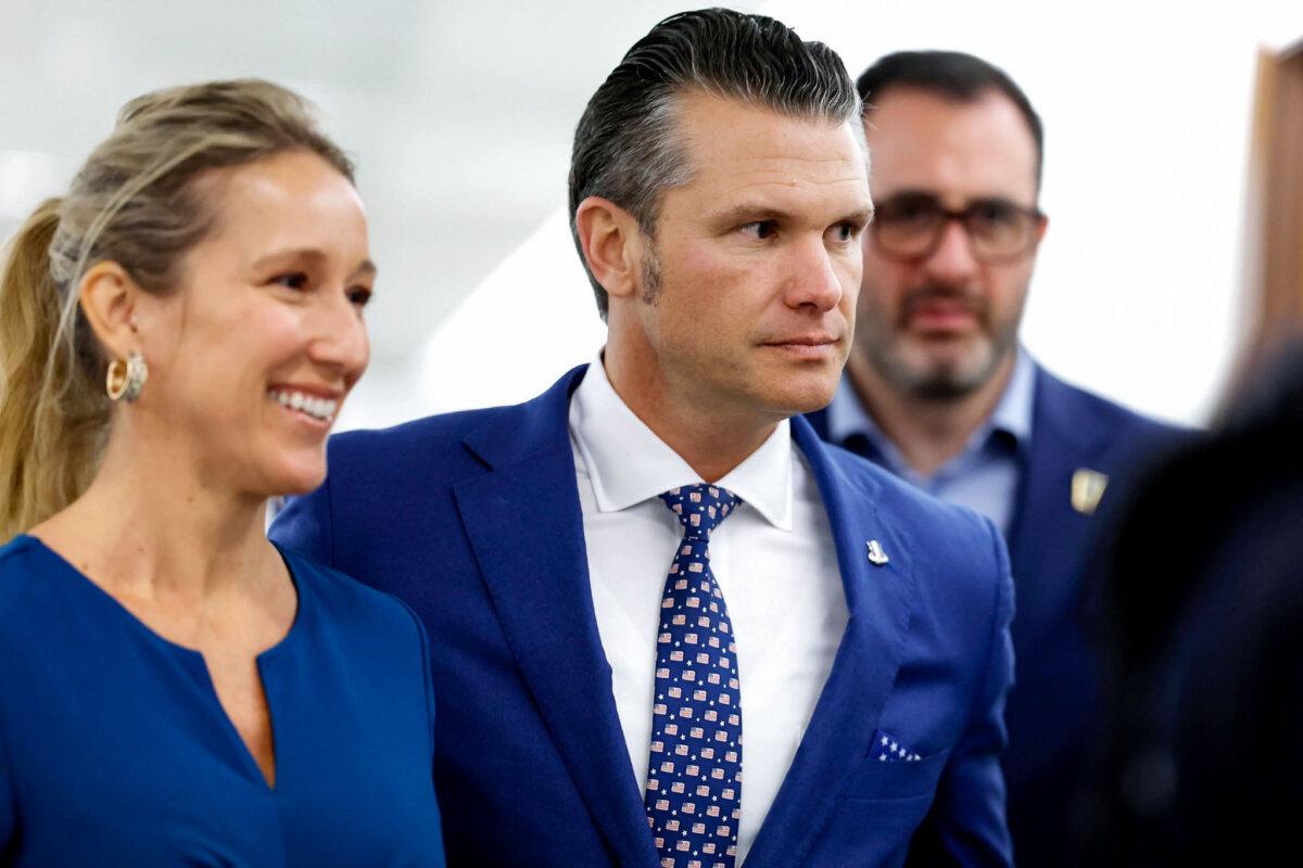 Pete Hegseth, President-elect Donald Trump's nominee to be secretary of defense, and his wife, Jennifer Rauchet, walk through the Hart Senate Office building in Washington on Dec. 11, 2024. (Anna Moneymaker/Getty Images)
