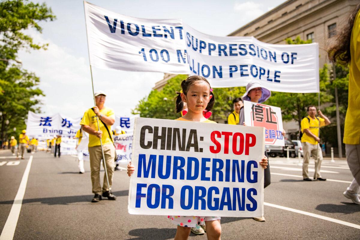 Falun Gong practitioners take part in a parade to celebrate World Falun Dafa Day, while calling for an end to the persecution against Falun Gong in China, in Washington on July 20, 2017. (The Epoch Times)