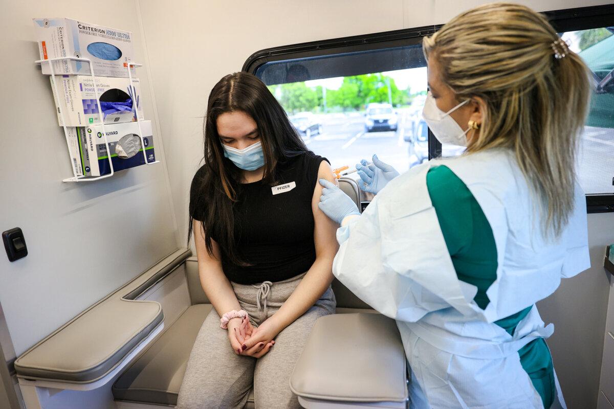Samira Moreno, 13, receives a Pfizer-BioNTech COVID-19 vaccine from Yelany Lima, a registered nurse, at UHealth's pediatric mobile clinic in Miami, Fla., on May 17, 2021. (Joe Raedle/Getty Images)