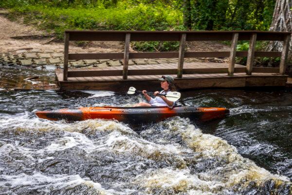 Kaley Deal navigates her way over Lainhart Dam on the Loxahatchee River on Nov. 5, 2024. (Patrick Connolly/Orlando Sentinel/TNS)