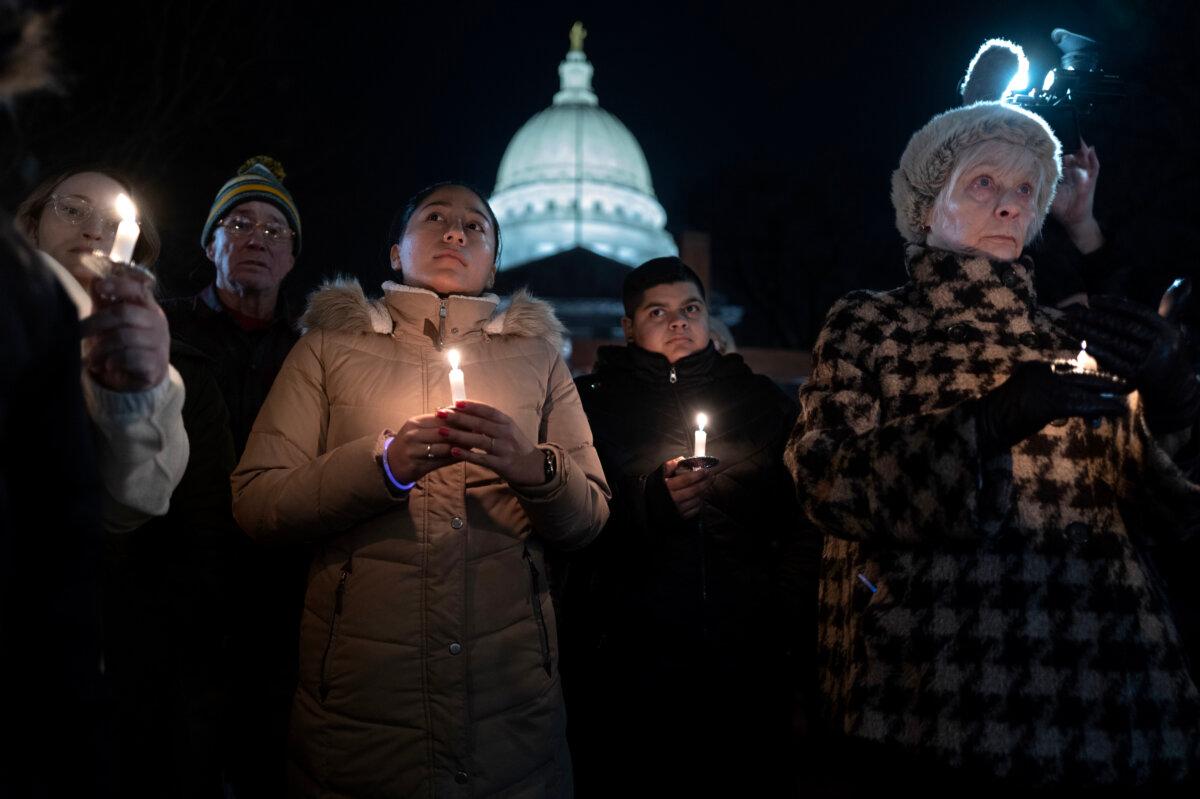 People attend a vigil on the grounds of the state Capital building to mourn the victims of the shooting at Abundant Life Christian School in Madison, Wis., on Dec. 17, 2024. (Scott Olson/Getty Images)