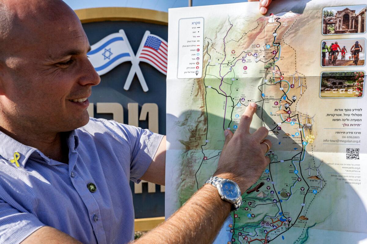 Yaakov Selavan, deputy head of Golan Heights Regional Council, points at the spot marking the Jewish settlement of "Ramat Trump" (Trump Heights), at the entrance of the settlement in the Israeli-annexed Golan Heights on Dec. 17, 2024. (Jalaa Marey/AFP via Getty Images)