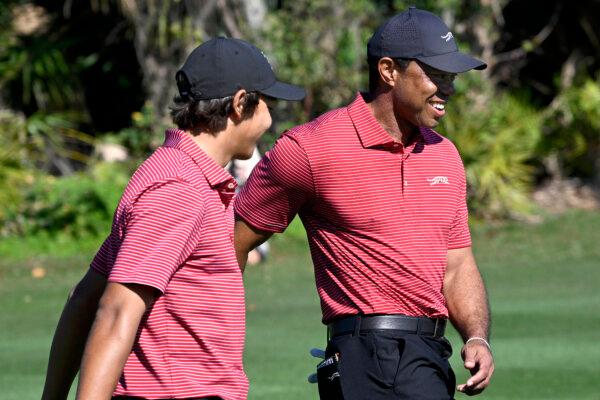 Tiger Woods (R) congratulates his son Charlie after his hole-in-one during the final round of the PNC Championship in Orlando, Fla., on Dec. 22. (Phelan M. Ebenhack/AP Photo)