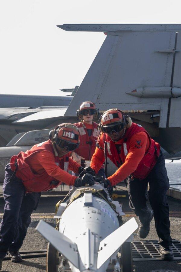 Sailors aboard the USS Harry S Truman prepare ordnance for strikes against Houthi targets in Yemen on Dec. 21, 2024. (Courtesy of U.S. Central Command.)
