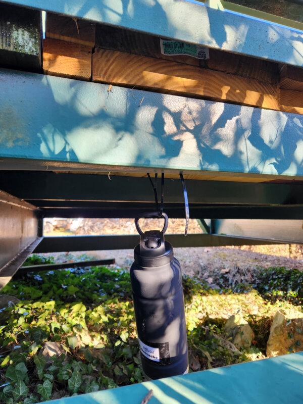 Hidden under a walking trail bridge, a beverage bottle holds treasures for geocachers to find. (Myscha Theriault/TNS)