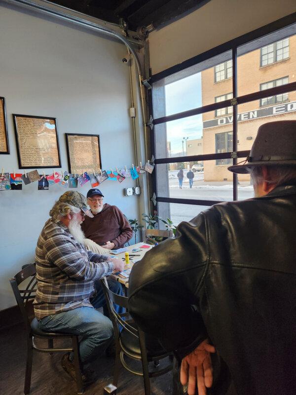 Geocachers socialize at a postcard making event held at a local tap house. (Myscha Theriault/TNS)
