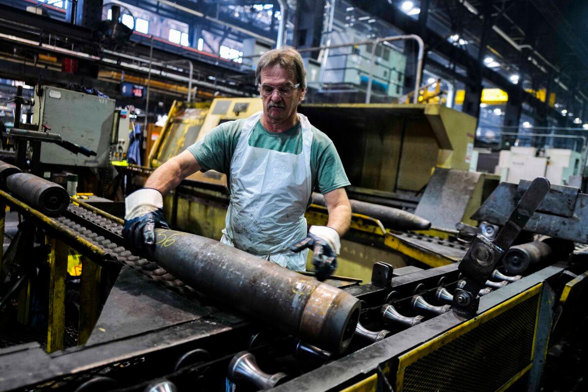 An employee handles 155 mm caliber shells after the manufacturing process at the Scranton Army Ammunition Plant in Scranton, Pa., on April 16, 2024. The plant is making steel tubes for 155 mm caliber shells, which are crucial to Kyiv's efforts to face down Moscow's invasion. (Charly Triballeau/AFP via Getty Images)
