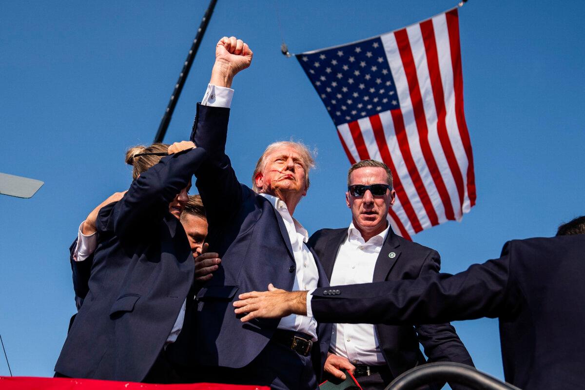 Republican presidential candidate former President Donald Trump raises his fist shortly after the assassination attempt at a campaign rally, in Butler, Pa., on July 13, 2024. (Evan Vucci/AP Photo)