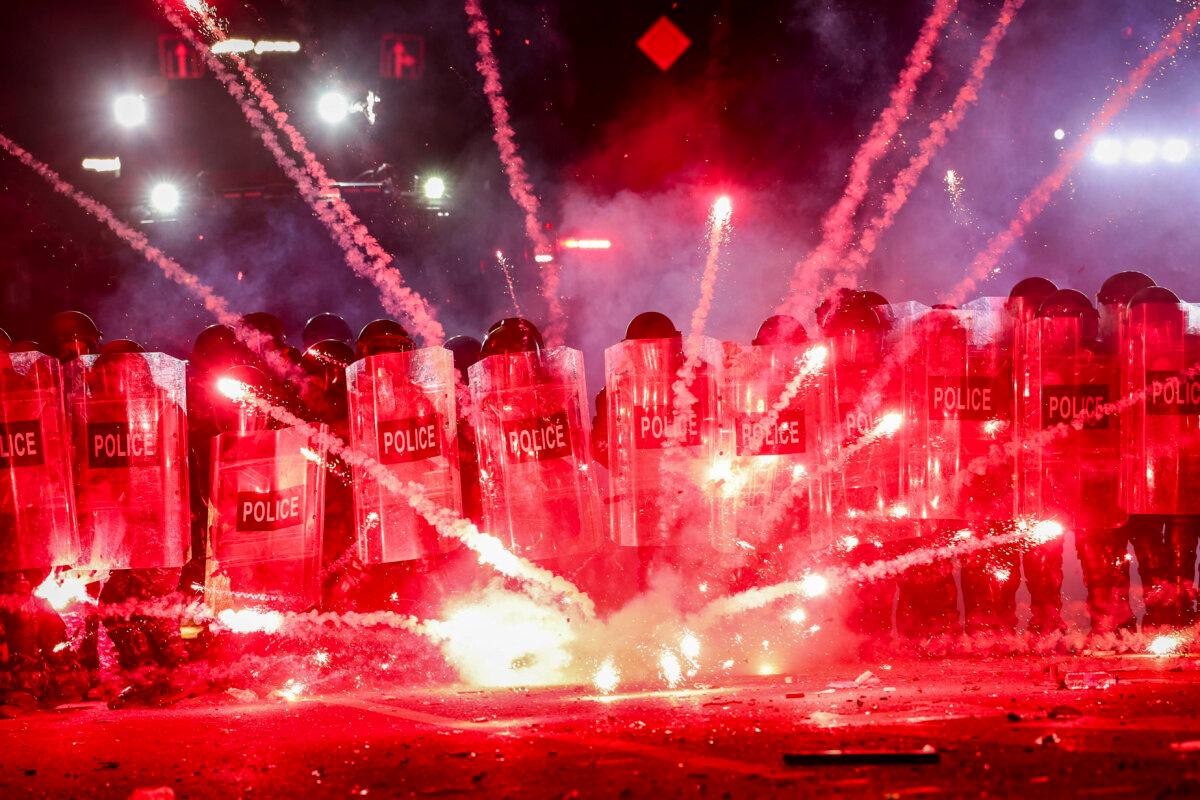 Georgian PM Decries Attempted Coup after Protests, Clashes Mar Local Polls 2 Fireworks fired by protesters explode along police lines during a demonstration in Tbilisi, Georgia, on Dec. 1, 2024. (Giorgi Arjevanidze/AFP via Getty Images)