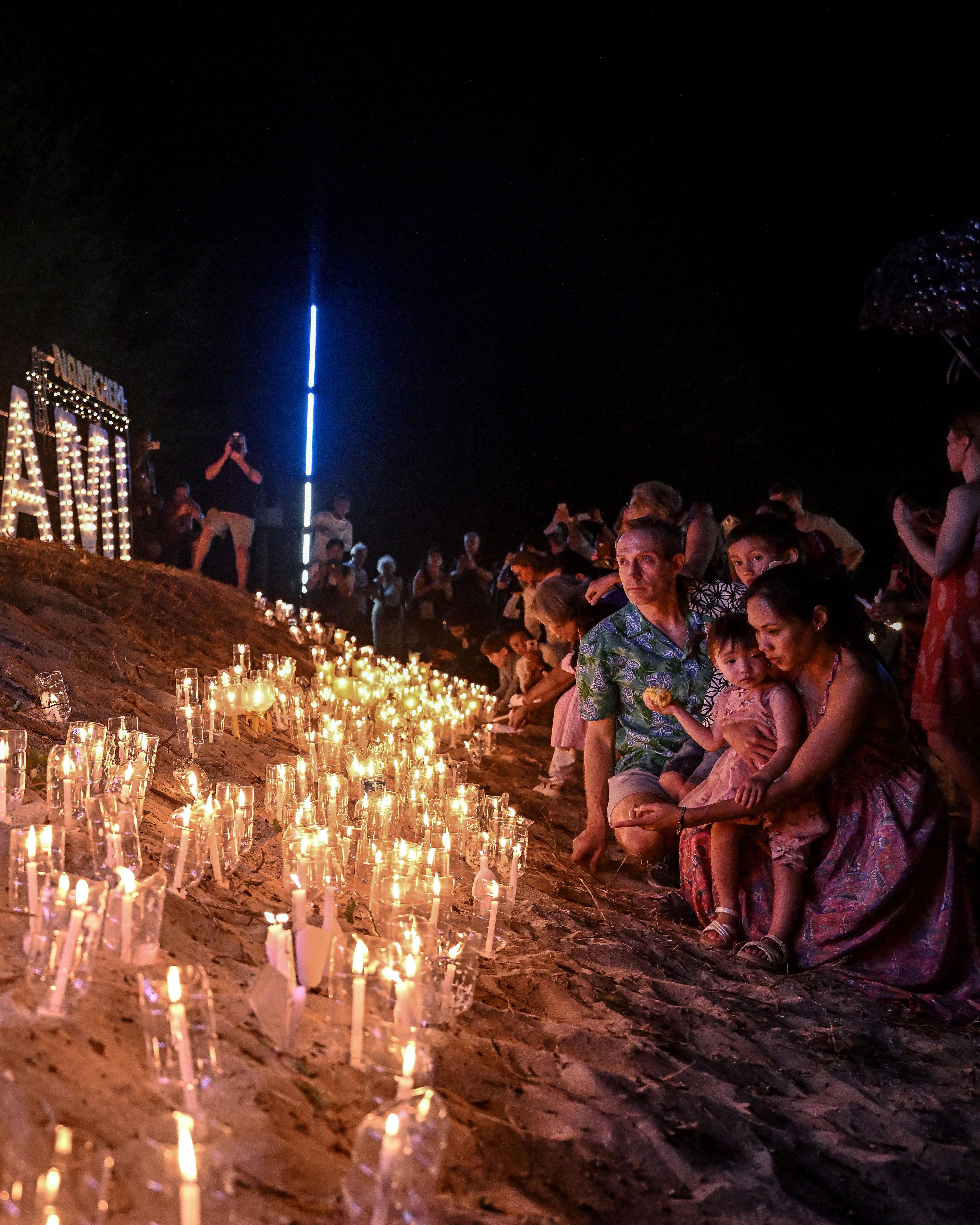 Day in Photos: Tsunami Memorial, Plane Crash in Kazakhstan, and Boxing Day Bath