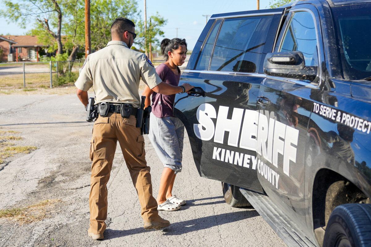 On July 22, 2022, Kinney County Sheriff's deputies arrest a woman on suspicion of illegal immigrant smuggling in Brackettville, Texas. (Charlotte Cuthbertson/Epoch Times)