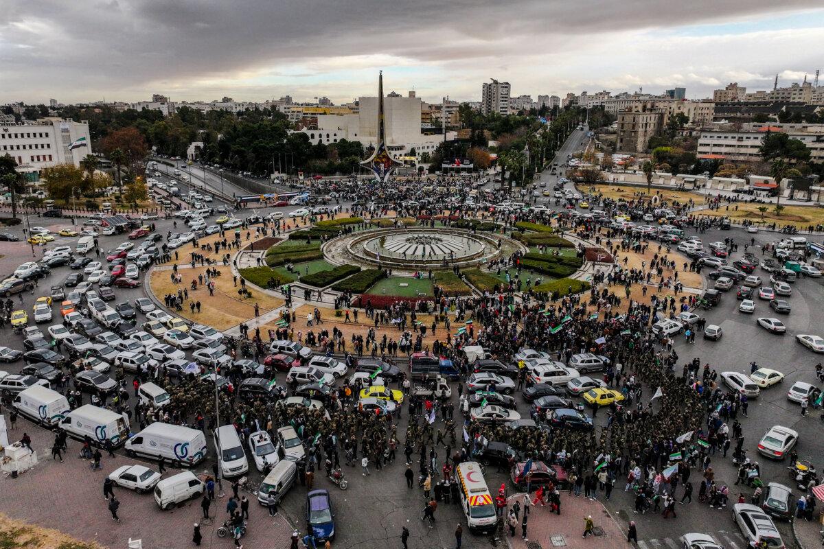 People and fighters affiliated with Syria's new administration gathered at Abbasid Square in Damascus, Syria, for a military parade on Dec. 27, 2024. (Omar Haj Kadour/AFP via Getty Images)