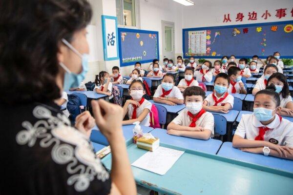 Elementary school students attend a class on the first day of the new semester in Wuhan, central Hubei Province, China, on Sept. 1, 2020. (STR/AFP via Getty Images)
