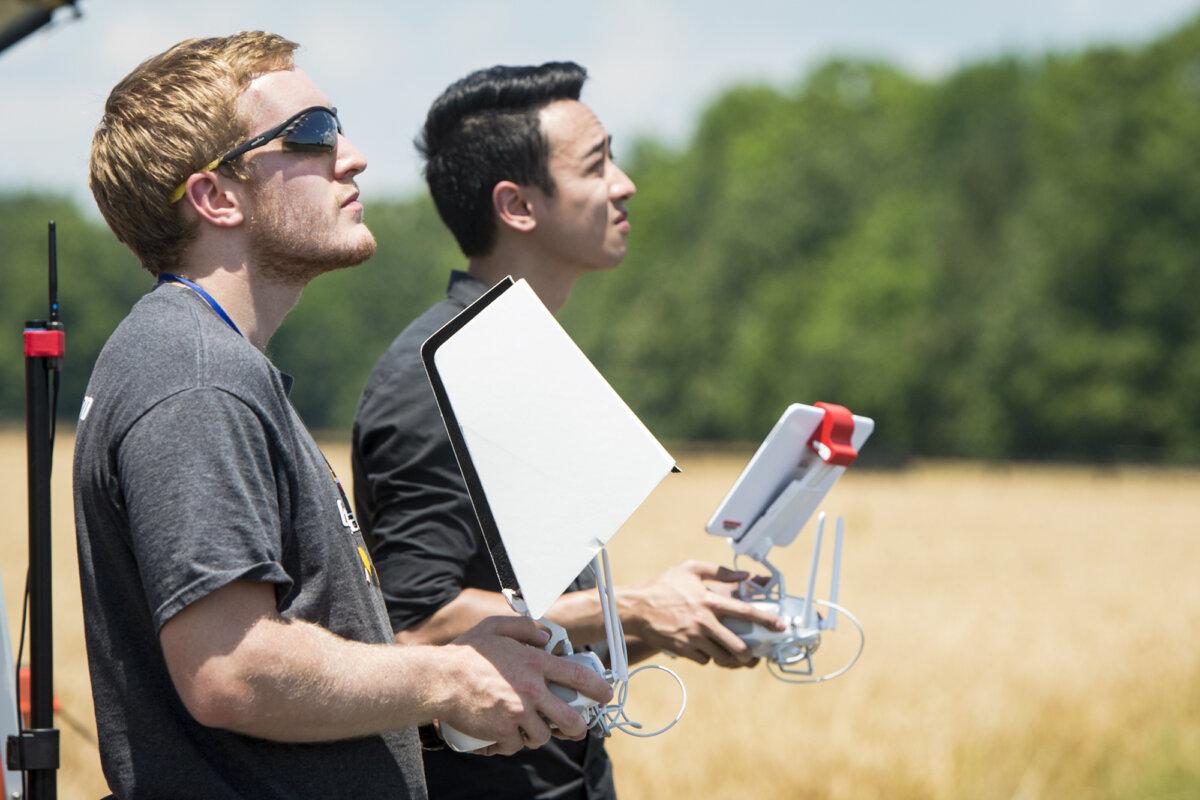 University of Maryland engineering students operate a DJI Inspire drone at a testing site for the university's Unmanned Aircraft Systems programs in Bushwood, Md., on June 24, 2016. At the time, the Federal Aviation Administration had unveiled new rules that cleared the way for commercial drones weighing less than 55 pounds to operate across the United States. (Saul Loeb/AFP via Getty Images)