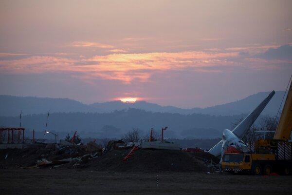 The sun rises behind debris and the wreckage of the aircraft that crashed after it went off the runway, at Muan International Airport, in Muan, South Korea, on Dec. 31, 2024. (Kim Hong-Ji/Reuters)