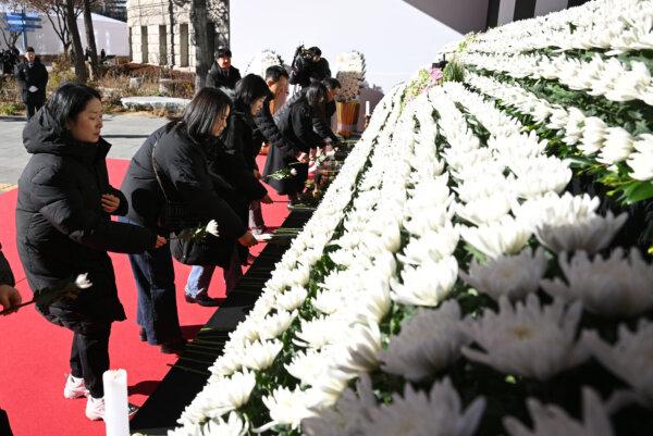 Mourners pay their respects at a memorial altar for the victims of the Jeju Air plane crash, in front of Seoul City Hall in Seoul on Dec. 31, 2024. (Jung Yeon-je/AFP via Getty Images)