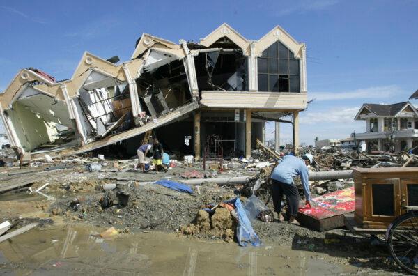 A survivor rummages through the debris at the commercial area of Banda Aceh, the capital of Aceh Province in northwest Indonesia, on Dec. 31, 2004.(Bullit Marquez/AP Photo)