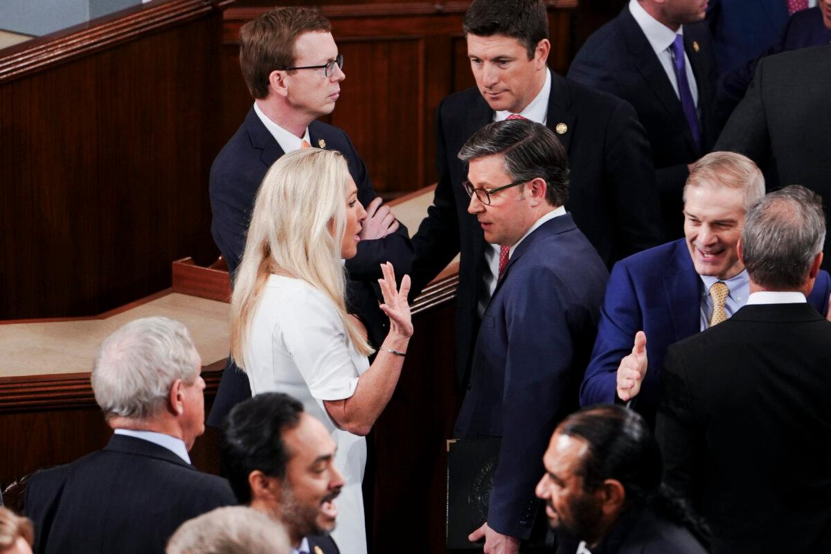 House Speaker nominee Mike Johnson (R-La.) speaks with Rep. Marjorie Taylor-Greene (R-Ga.) on the first sitting of the 119th Congress in Washington on Jan. 3, 2025. (Madalina Vasiliu/The Epoch Times)