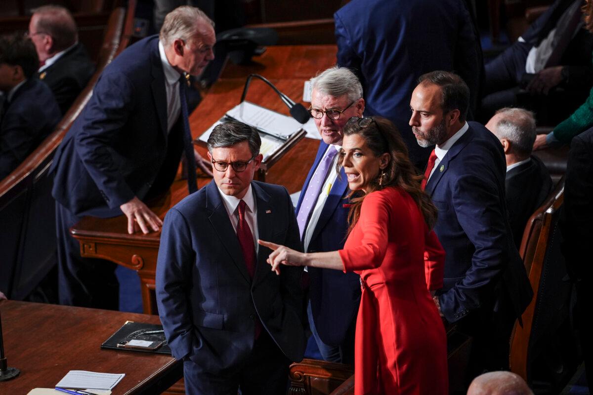 House Speaker nominee Mike Johnson (R-La.) speaks with Rep. Nancy Mace (R-S.C.) on the first sitting of the 119th Congress in Washington on Jan. 3, 2025. (Madalina Vasiliu/The Epoch Times)