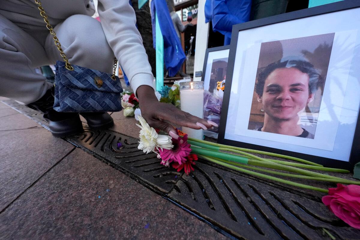 New Orleans Mourns Victims of Truck Attack With Tearful Vigil and Celebration of Life 2 A woman places flowers next to photos of victim Matthew Tenedorio at memorial on Canal Street for the victims of a deadly truck attack on New Year's Day in New Orleans on Jan. 3, 2025. (Gerald Herbert/AP Photo)