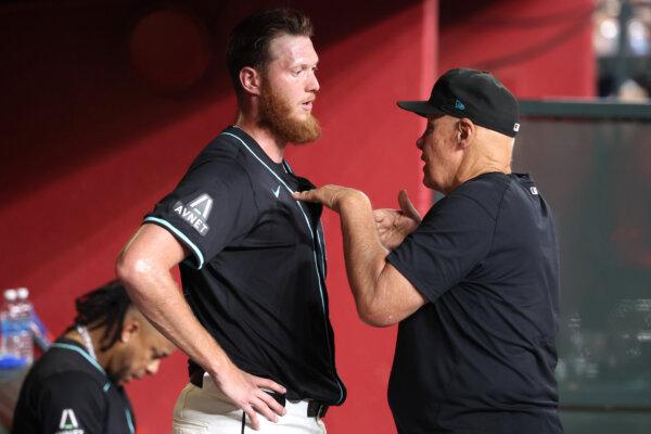 Pitching coach Brent Strom #72 of the Arizona Diamondbacks talks with relief pitcher A.J. Puk #33 after the eighth inning against the Pittsburgh Pirates at Chase Field in Phoenix on July 27, 2024. (Chris Coduto/Getty Images)