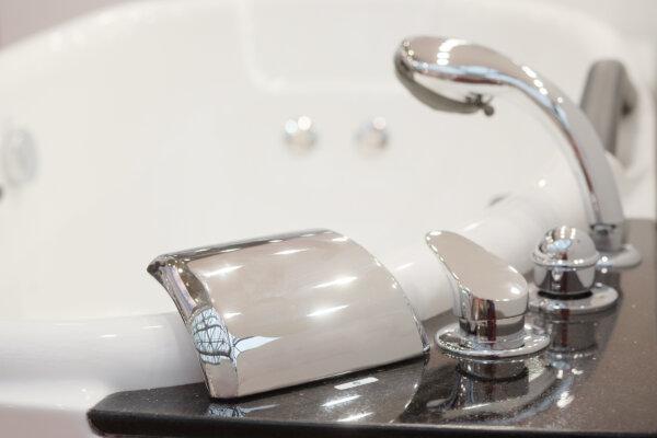 Vinegar can be used to clean bathroom tiles, the tub and toilet, and even the shower head. (Vereshchagin Dmitry/Shutterstock)